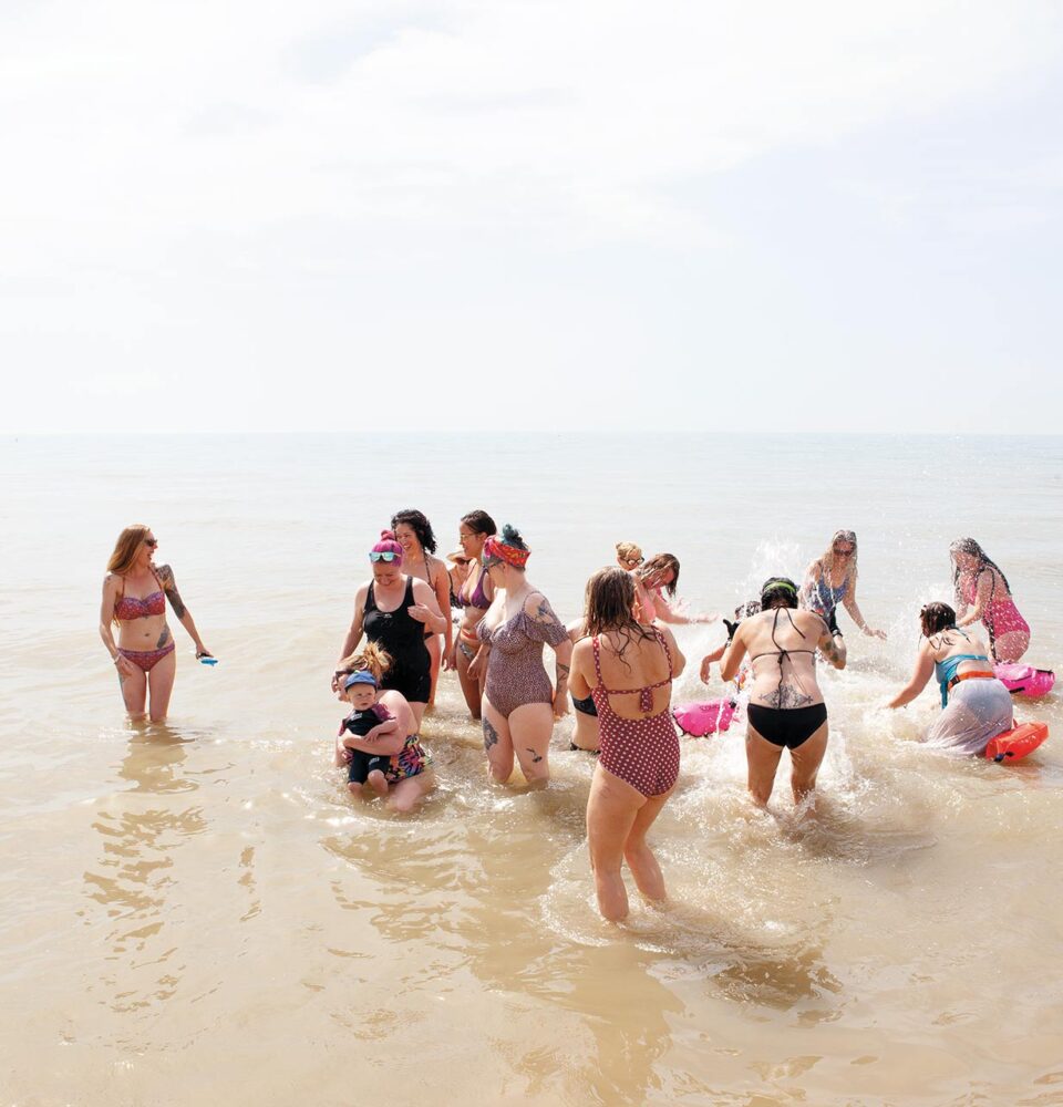 A group of Hastings' swimmers in the shallows having a whale of a time
